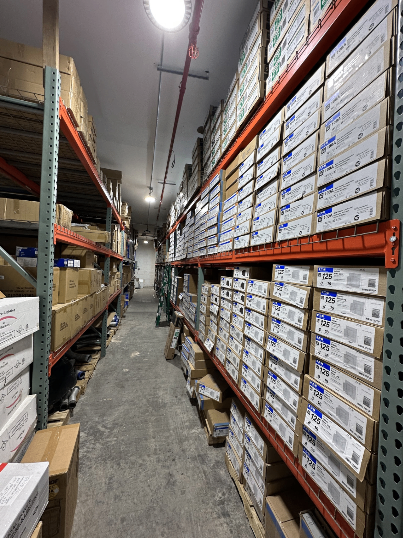 Aisle stacked floor to ceiling with Eaton breaker boxes and panels